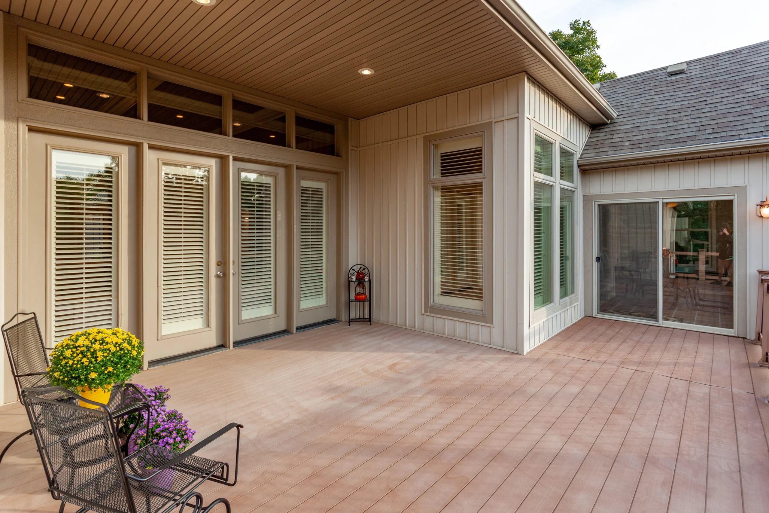 AboutUs_Warranty_ParallaxBKGD wide back porch with many doors